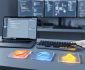 “Modern developer workspace with laptop, keyboard, and colorful tech-shaped tiles representing web development layers on a desk under natural daylight.”